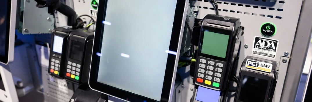 Hardware components and payment terminals of a mid-range interactive shopping kiosk highlighting hidden deployment costs like PCI EMV certification and ADA compliance. Hardware components and payment terminals of a mid-range interactive shopping kiosk highlighting hidden deployment costs like PCI EMV certification and ADA compliance.